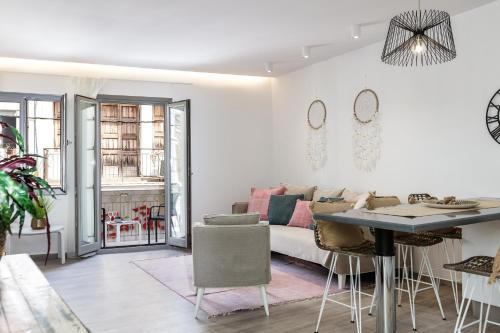 a living room with a couch and a table at Kristin's Maisonette - Roof Terrace & Sauna in Rethymno Town