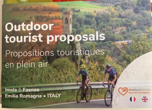 a poster of two people riding bikes on a road at La Colombara - Fra i colli a 5 minuti dall'autodromo in Imola