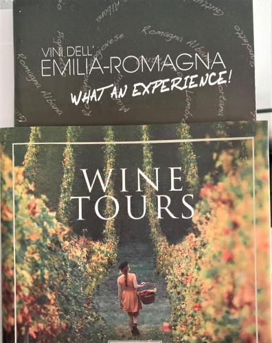 a book about wine tours with a woman walking through a vineyard at La Colombara - Fra i colli a 5 minuti dall'autodromo in Imola