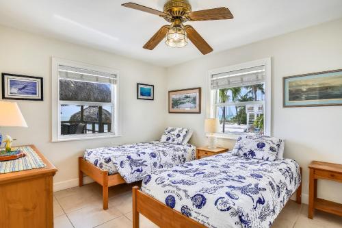 a bedroom with two beds and a ceiling fan at The Henry Flagler in Layton
