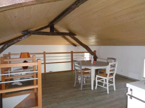 a room with a table and chairs in a attic at location chambre d hotes clodeguy No 1 in Saint-Sylvestre-sur-Lot