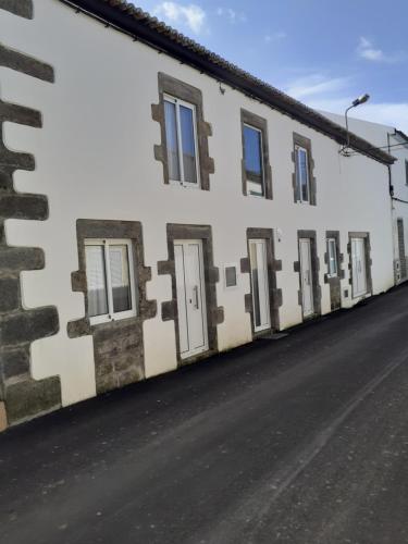 a row of windows on a white building at Basaltic Guest House in Achadinha