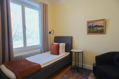 a small bedroom with a bed with a window at Park Hotell in Kristinehamn