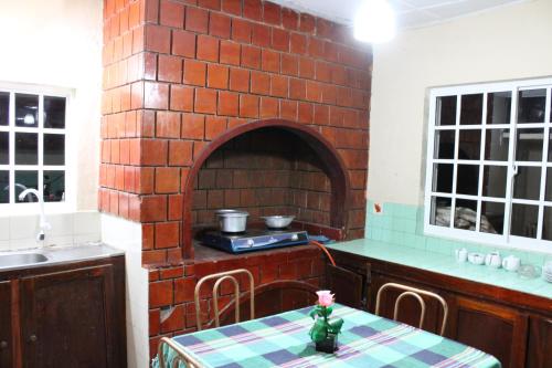 A kitchen or kitchenette at Blossomwell Bungalow