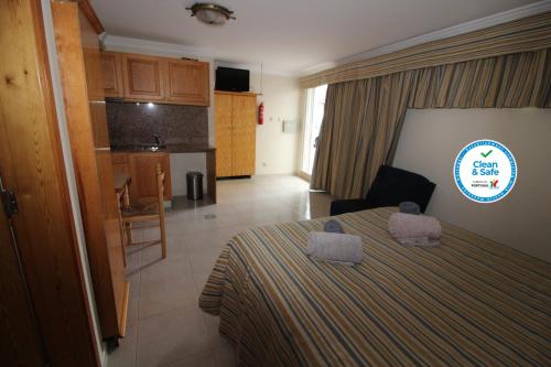 a hotel room with a bed and a kitchen at Waves Studio - Albufeira in Albufeira