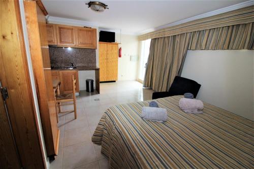 a bedroom with a bed with two towels on it at Waves Studio - Albufeira in Albufeira