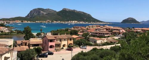 a view of a town with a lake and mountains at Villa BOREA in Golfo Aranci