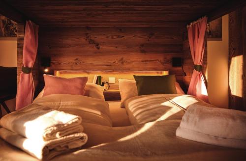 a bedroom with a large bed with pillows at Die Tauplitz Lodges - Penthouse Grimming D7-1 by AA Holiday Homes in Tauplitz
