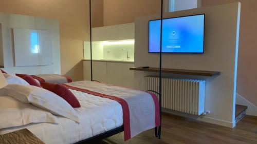 a bedroom with a bed and a flat screen tv at Dimora del Leone Gaeta in Gaeta