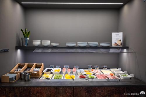a buffet line with different types of food on display at Best Western Hotel Turismo in San Martino Buon Albergo