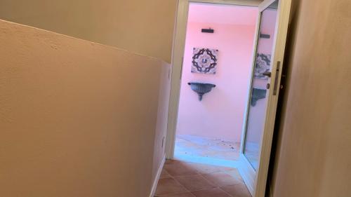 a hallway with a glass door leading to a bathroom at Dimora del Leone Gaeta in Gaeta