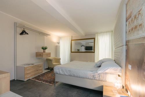 a bedroom with a bed and a dresser and a mirror at Hotel Giulietta e Romeo ***S in Verona