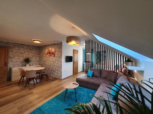 a living room with a couch and a table at Réteskert vendégház és apartman in Bélapátfalva