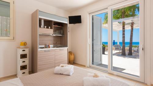 a kitchen with a view of the ocean at Tenuta Scialandre 10, Emma Villas in Patù