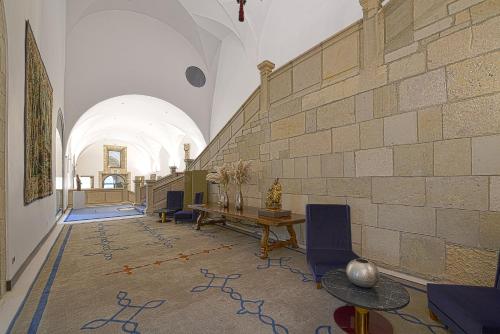 a room with a table and chairs in a building at Parador de Turismo de León in León