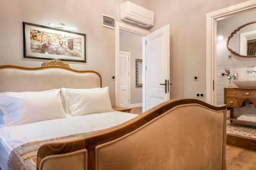 a bedroom with a white bed and white pillows at Hotel Lykia Old Town Antalya in Antalya