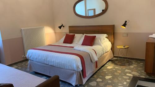 a bedroom with a large bed and a mirror at Dimora del Leone Gaeta in Gaeta