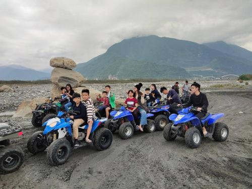 a group of people riding atvs on a dirt road at Xincheng Old Street B&B in Xincheng