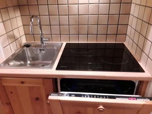 a kitchen with a sink and a sink at Apartments "STELLA ALPINA" in Santa Caterina Valfurva