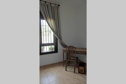 a room with a table and a window at Beautiful Duplex with a Patio in Alcalá de los Gazules