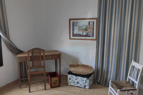 a room with a desk and a chair and a table at Beautiful Duplex with a Patio in Alcalá de los Gazules