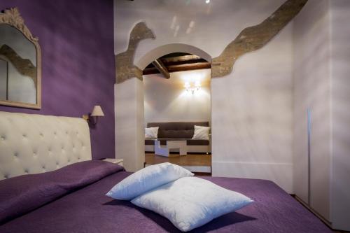 a purple bedroom with a bed with a white pillow at Villa Ca' Viola Rimini in Rimini