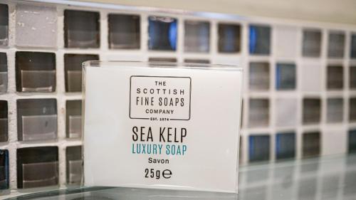 a bottle of soyhelp liquid soap sitting on a shelf at Western Isles Hotel in Tobermory