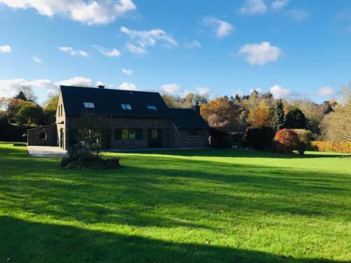 a house on a green field with a large yard at Lovely Meadow House in the land of Croix Scaille in Gedinne