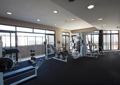 a gym with treadmills and machines in a building at Estanplaza International in Sao Paulo