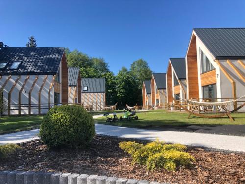 a row of houses with a park in front at Vacanza Park in Łeba
