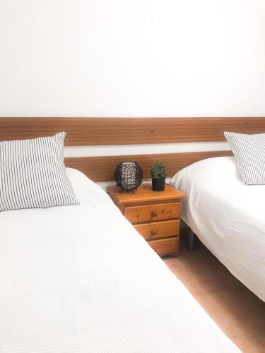two beds sitting next to each other in a bedroom at peñiscola playa primera linea ,parquing incluido in Peñíscola