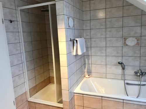 a bathroom with a shower and a bath tub at Lovely Meadow House in the land of Croix Scaille in Gedinne