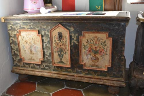 an old chest with paintings on the side of it at B&B La Tana dell'Orso - Die Bärenhöhle in Castello di Fiemme