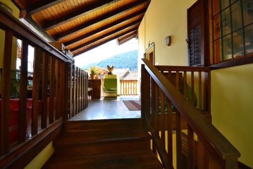 a hallway of a house with wooden stairs at B&B La Tana dell'Orso - Die Bärenhöhle in Castello di Fiemme