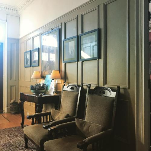 a room with chairs and a table and a desk at Ashtree House Hotel, Glasgow Airport & Paisley in Paisley