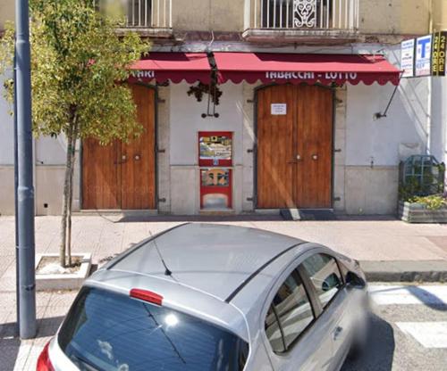 a silver car parked in front of a building at Station's Room in Avellino