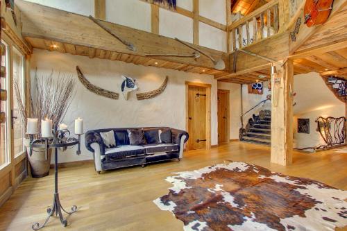 a living room with a couch and a table at La Ferme du Lac Vert in Montriond