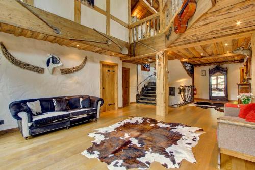 a living room with a couch and a rug at La Ferme du Lac Vert in Montriond