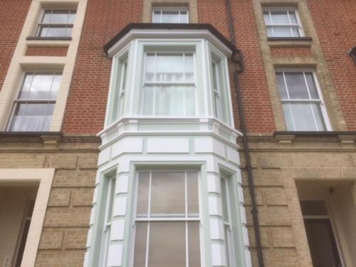a tall brick building with white windows on it at Moray Beachside Apartments in Lowestoft