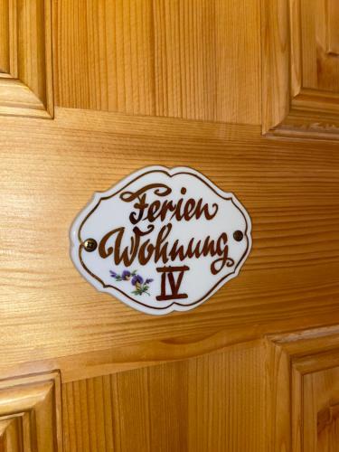 a sign on a wooden door with the words senior welcomingwx at Villa Borchert in Wernigerode