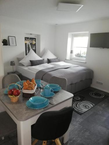 a bedroom with a bed and a table with food on it at Ferienwohnung Hirmer in Zirndorf