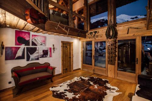 a living room with a red couch and a rug at La Ferme du Lac Vert in Montriond