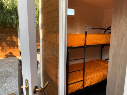 a door leading to a room with bunk beds at Camping roccella mare in Campofelice di Roccella
