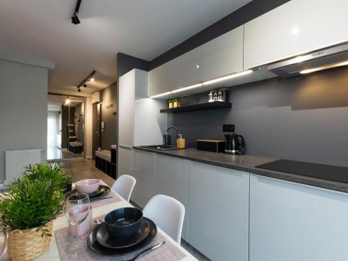 a kitchen with a table and chairs in a room at VacationClub – Unieście-Szafirowa Mierzeja 9 in Mielno
