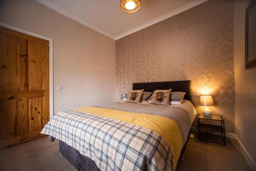 a bedroom with a bed with two pillows on it at Fisherman Cottage in Wick