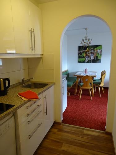 an open kitchen and dining room with a table at Appartementhaus Kaltenbach-Stumm by PiaundDirk in Stumm