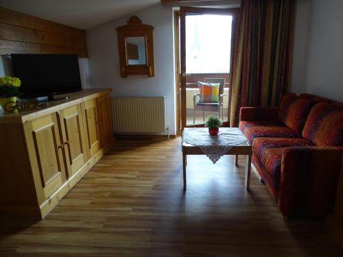 a living room with a couch and a table at Appartementhaus Kaltenbach-Stumm by PiaundDirk in Stumm