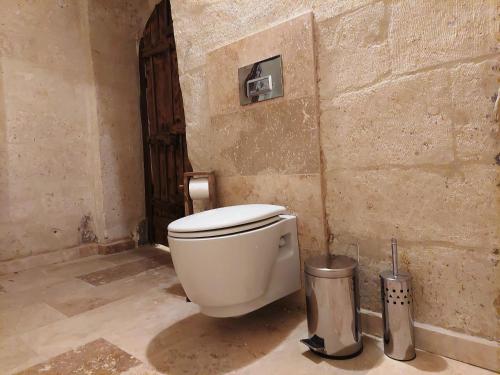 a bathroom with a white toilet in a room at ARMEsos Cave Hotel in Urgup