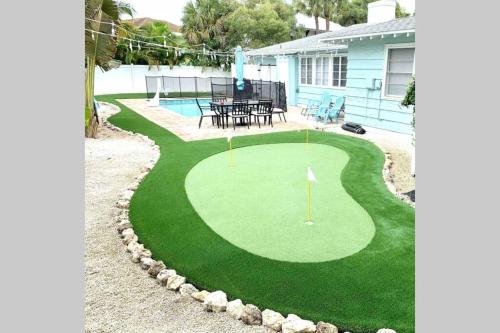 a putting green with a table and a golf course at One-of-a-kindBeach, Village, Dock & Private Pool! in Siesta Key