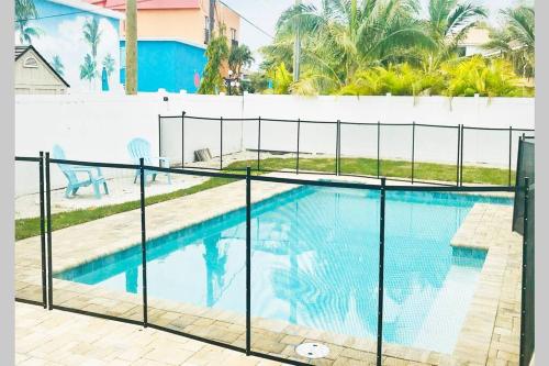 a swimming pool with a fence around it at One-of-a-kindBeach, Village, Dock & Private Pool! in Siesta Key